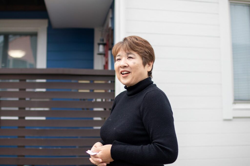 家の前で、笑顔で話しているH様。