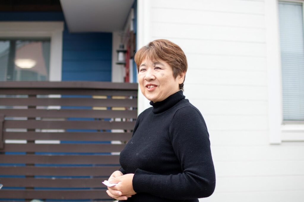 家の前で、微笑んでいるH様。